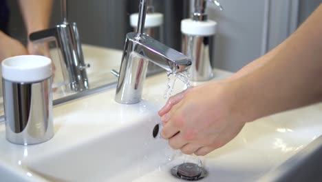 slow-motion of white male washing hands