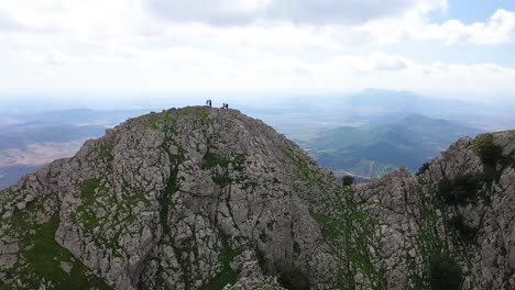 A-circling-areal-shot-of-the-peak-of-Zaghouan-in-Tunisia-with-some-hiking-tourists-on-the-top