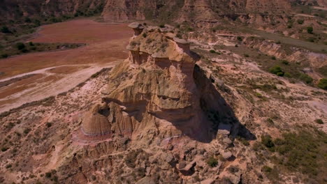 Mid-speed-flight-around-a-cliff-in-a-desert-environment