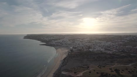 praia da luz resort town overlooking calm atlantic ocean at sunset. beach holidays concept