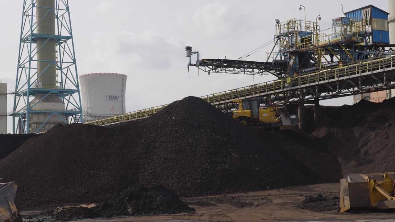 Industrial Sand Factory, Bulldozer pushing rocks and sand down a hill - smooth slow-motion shot