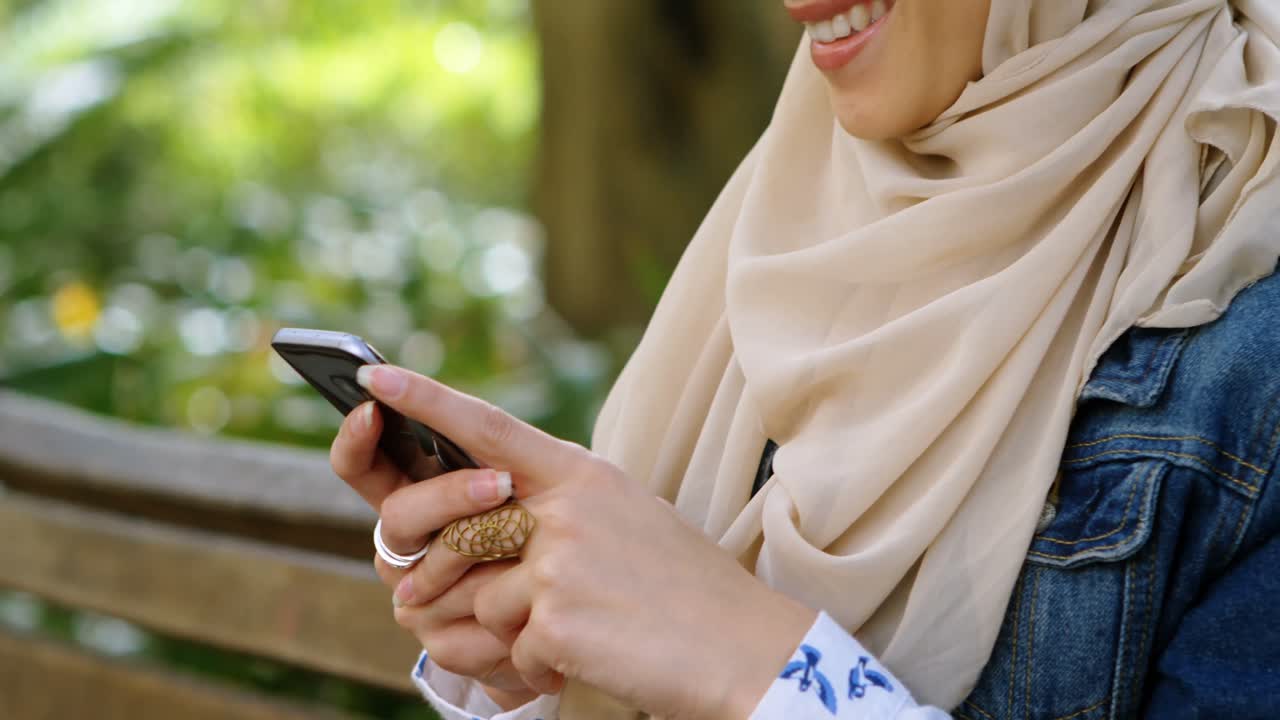 Woman in hijab using mobile phone 4k