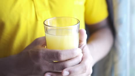 person holding a glass of juice