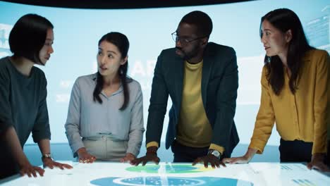 business team meeting around interactive display