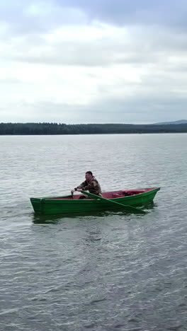 man rowing a boat on a lake