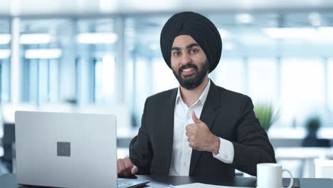 happy sikh indian businessman showing thumbs up