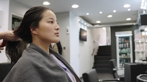 woman getting her hair styled in a salon