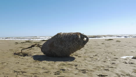 old buoy washed onto a beach in italy