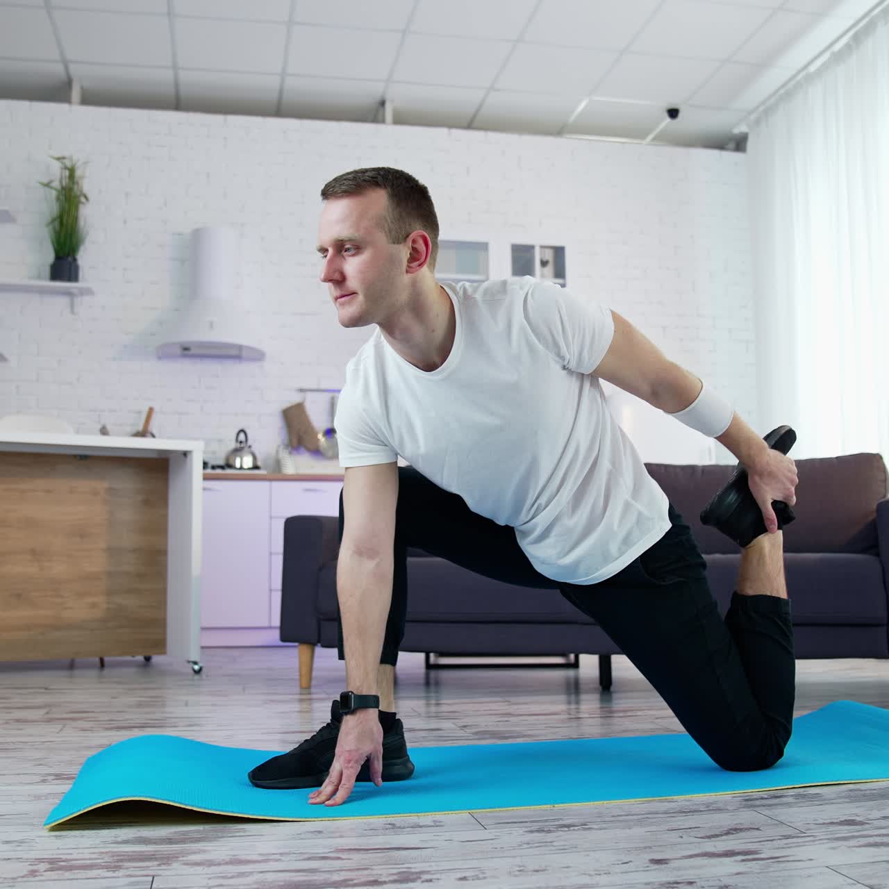 Young fit man in sportswear working out at home. Healthy lifestyle man doing yoga on quarantine