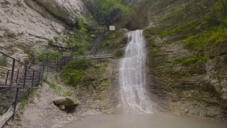 waterfall in a mountain canyon with stairs