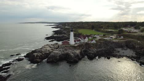 aerial drone shot circling historic maine lighthouse