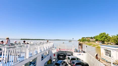 ferry docking with passengers and vehicles onboard