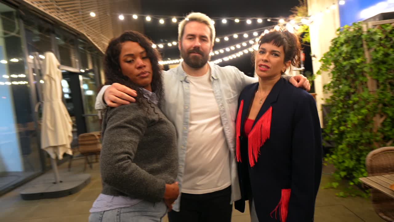 Friends posing together at night