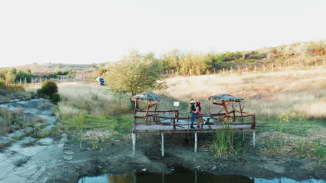 inlove couple spending a romantic evening on a pontoon in a rural area