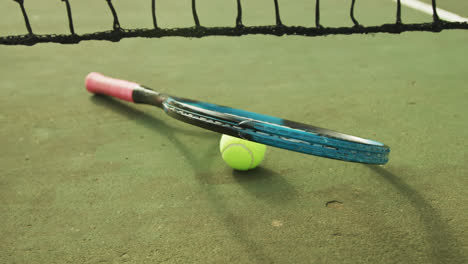 video of tennis racket and tennis ball on the green court