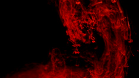 tinta roja ascendiendo como en una gran explosión, sobre un fondo negro