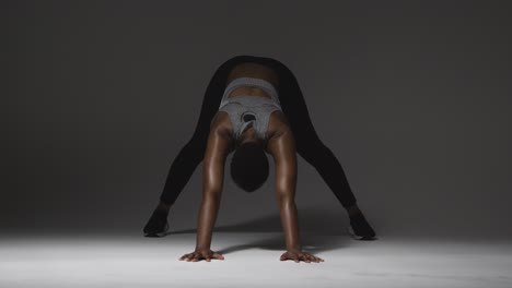 Studio-Shot-Of-Young-Woman-Wearing-Gym-Fitness-Clothing-Warming-Up-For-Exercise-7