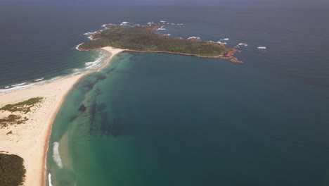 fingal bay beach and fingal island in new south wales, australia - aerial drone shot