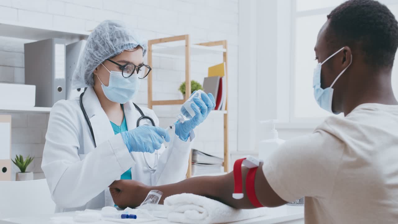 Doctor giving injection to patient