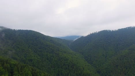 aerial view. flying over the high mountains in beautiful clouds . aerial camera shot