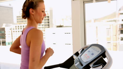 fit woman running on treadmill