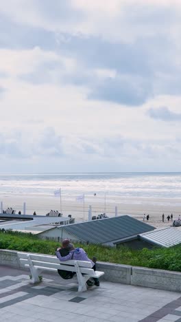 couple relaxing on beachfront bench