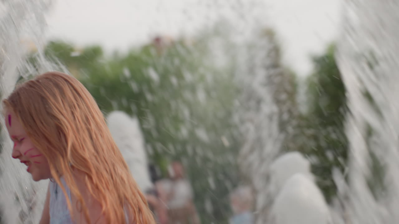 Playful girl running through splash fountain, shoulder view, water spraying over her, joyful motion, summer park play, wet droplets cascading, carefree energy, blurred green background
