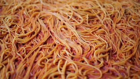 Large-pile-of-spaghetti-with-tomato-sauce,-pasta-Bolognese-close-up