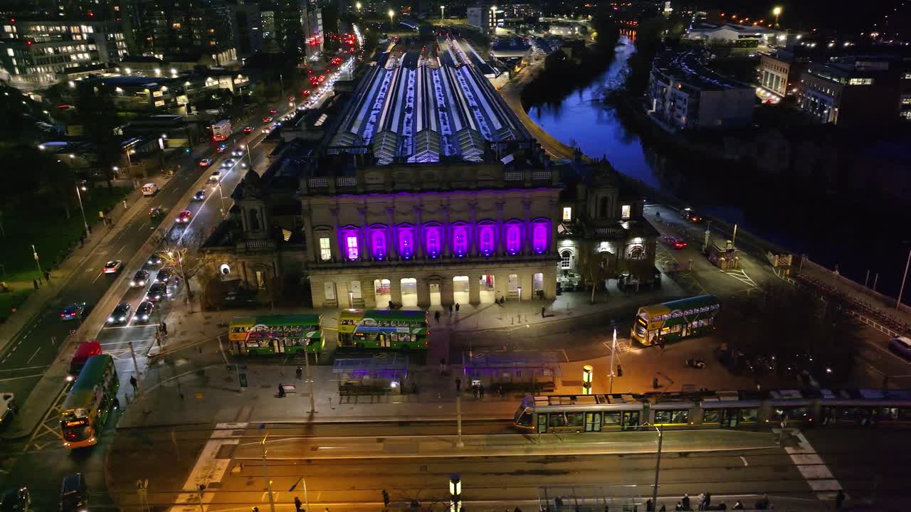 4K cinematic drone footage of Heuston Station in Dublin at sunset, highlighting the historic building, approaching trains, and the Dublin skyline under dramatic sunset hues. Dublin_034
