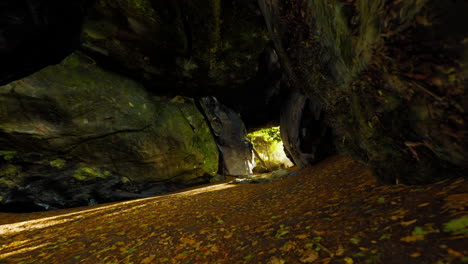 mysterious rock formation cave in autumn forest