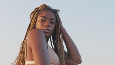 African-girl-playing-with-her-braids-on-a-beach