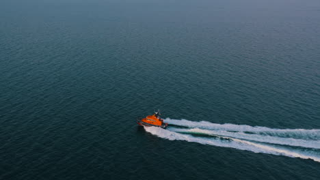 aerial view, shot in 4k, following a life boat, rnli, on a training mission