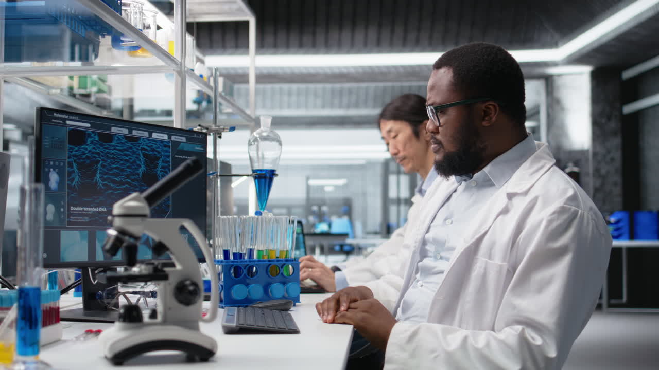 Vertical video Scientist working on PC in lab, evaluating genetic markers