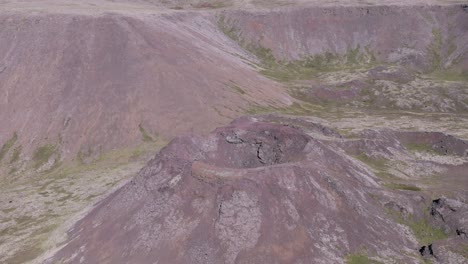 Aerial-flying-towards-old-volcanic-crater-consisting-of-scoria-rock