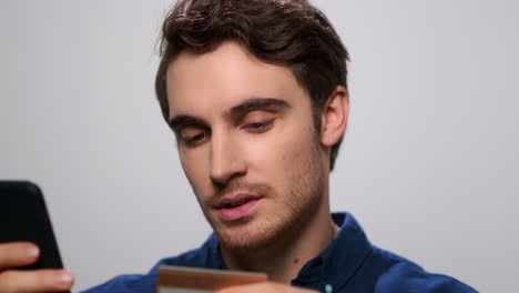 guy using bank card for online shopping. man doing online payment from bank card