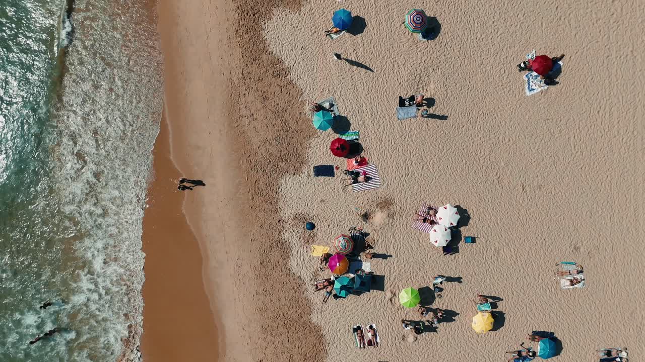 Aerial View of Beach with People and Umbrellas
