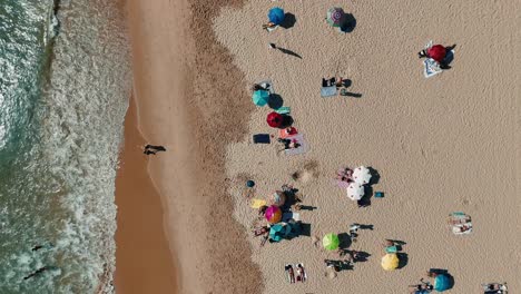 aerial view of beach with people and umbrellas