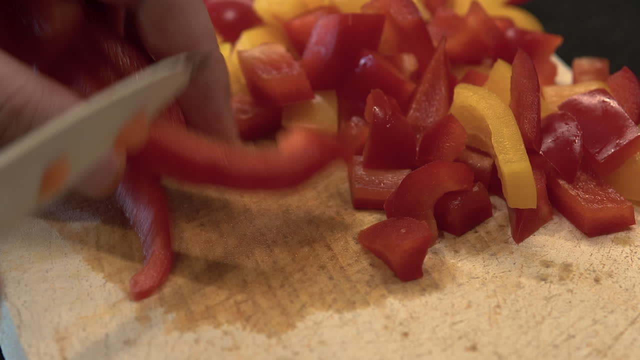 Chopping red and yellow peppers