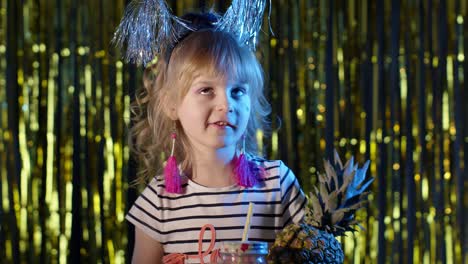 Trendy-stylish-child-kid-with-pineapple-fruit-drinking-juice-in-futuristic-club-with-neon-light