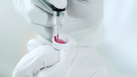 typing red pigment in a tattoo machine for permanent makeup