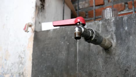 tap closeup with flowing water-drop