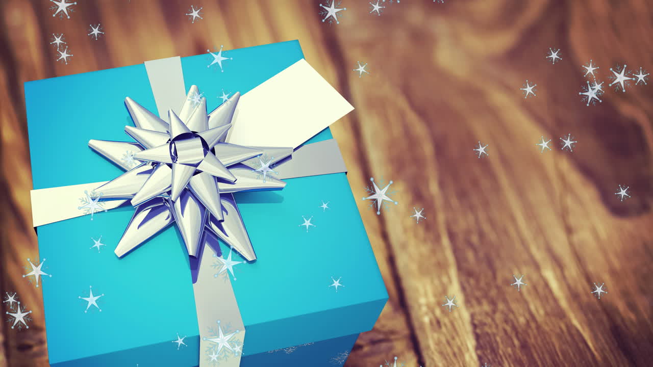 animación de la nieve cayendo sobre el presente en fondo de madera