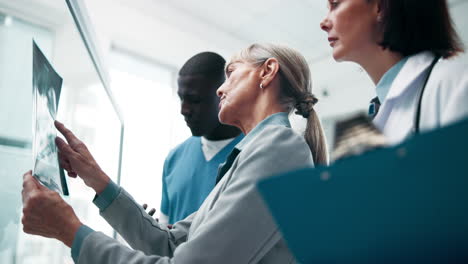 medical team reviewing patient x-ray