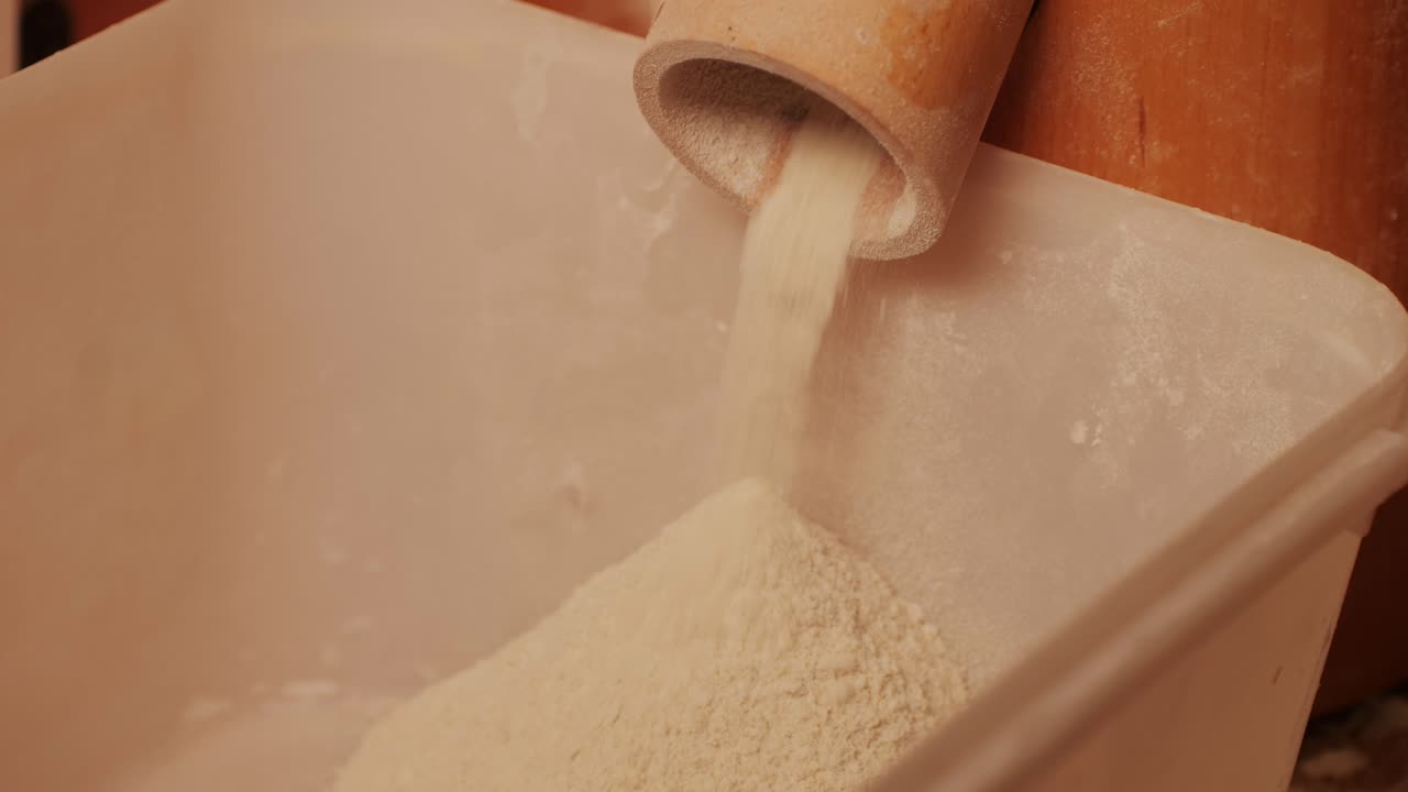 Machinery making flour in wheat flour in bakery or factory, electrical mill machinery. Wheat against diseases and insects using modern equipment. Clip. Concept of food industry. Small business concept . High quality 4k footage