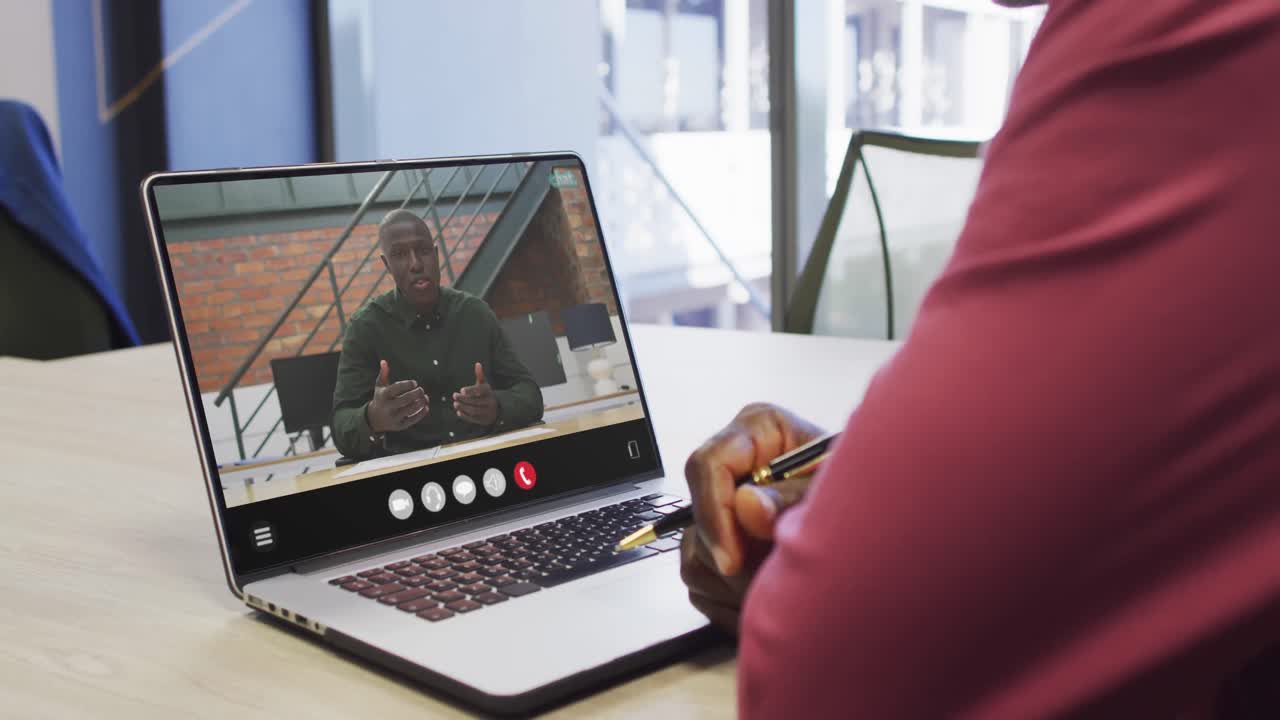 African american man using laptop for video call, with business colleague on screen