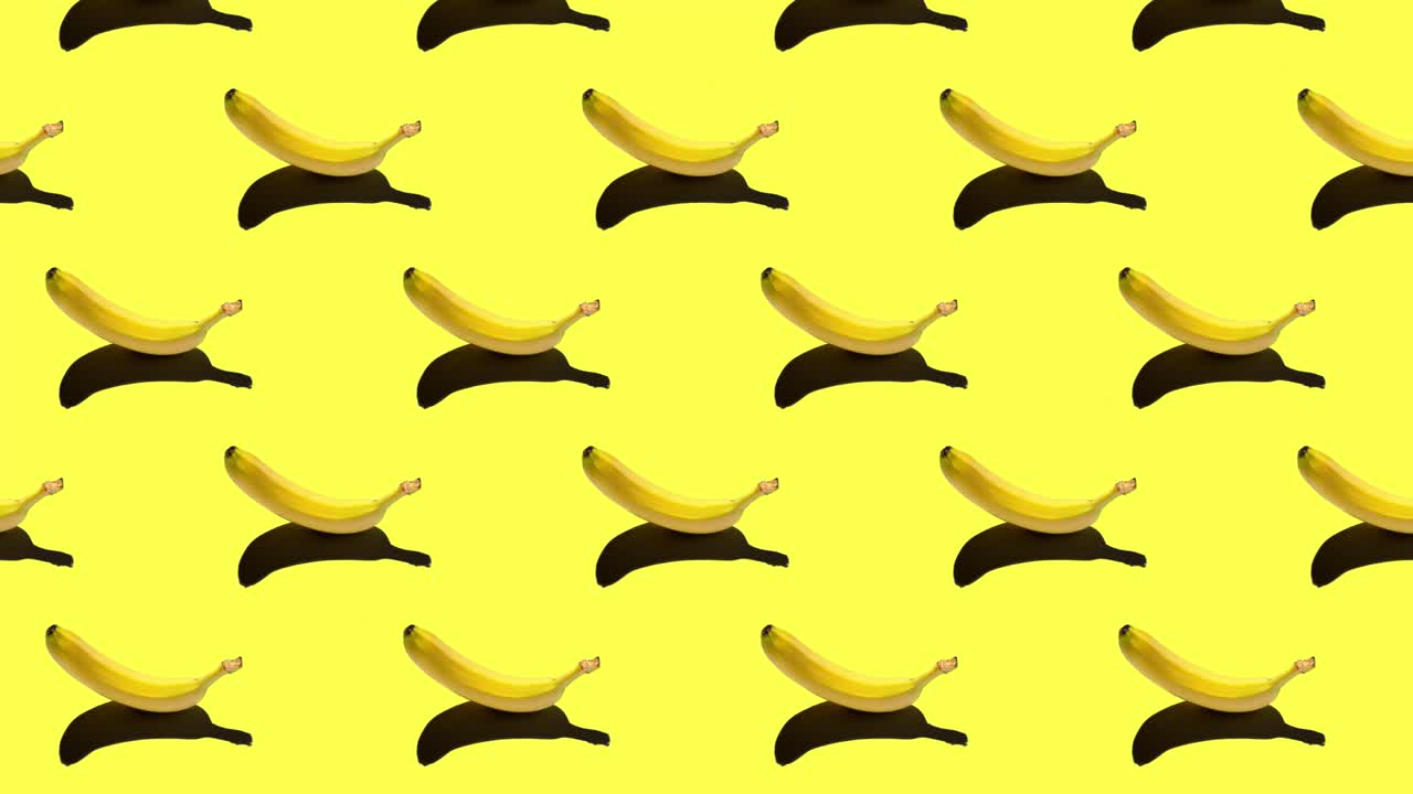 밝은 배경에 고립 된 익은 노란 바나나와 함께 패턴의 원활한 루프 애니메이션. 정오에 태양에서 단단한 그림자