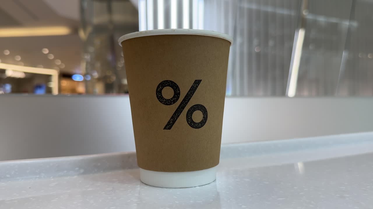 A Paper Coffee Cup with a Percent Symbol Logo