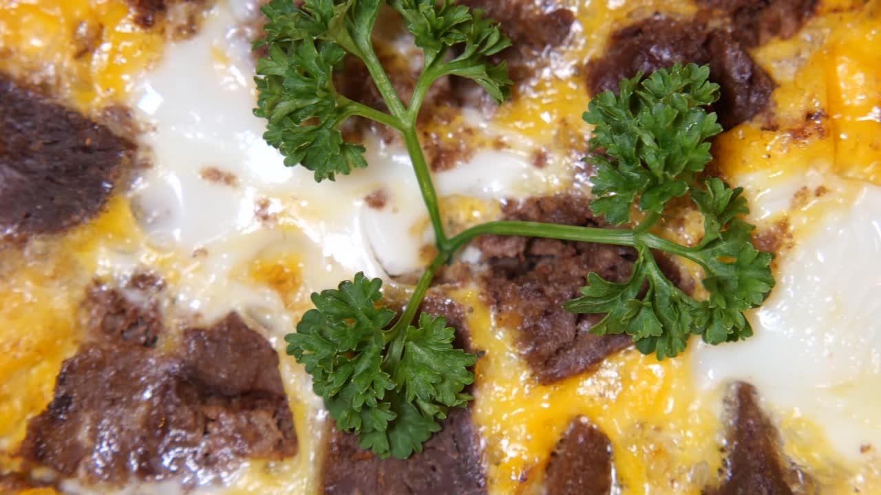 Close-up of a delicious and savory baked egg dish with meat
