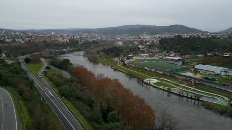 Oira-and-Miño-river-with-winding-pedestrian-bridge-crossing-water,-Ourense-Spain