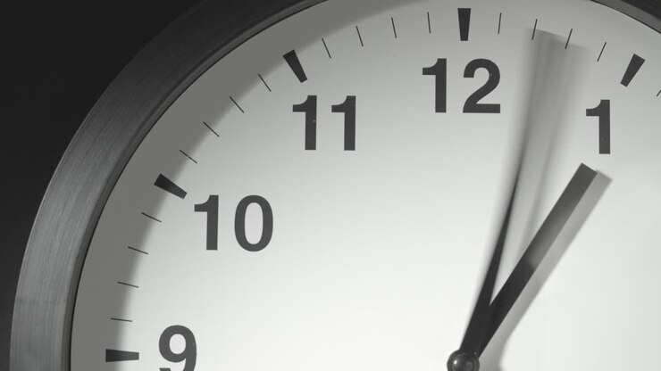 Clock Face in Time Lapse on Dark Grey Wall